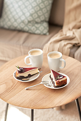 Image showing pieces of chocolate cake on wooden table