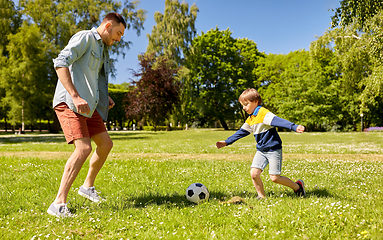 Image showing father with little son playing soccer at park