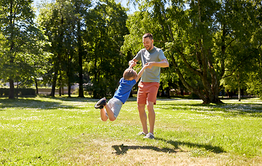 Image showing happy father with son playing in summer park