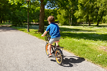 Image showing little boy riding bicycle at summer park