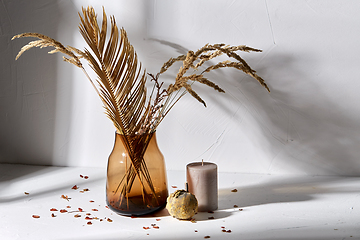Image showing dried flowers in glass vase candle and pumpkin