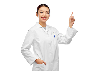 Image showing happy asian female doctor pointing finger up