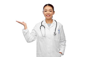 Image showing asian female doctor holding something on hand