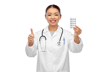 Image showing asian female doctor with pills showing thumbs up