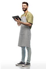 Image showing smiling waiter in apron with tablet pc computer