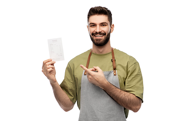 Image showing happy smiling barman in apron with bill