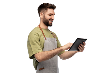 Image showing smiling waiter in apron with tablet pc computer