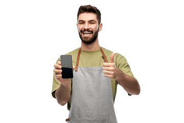 Image showing happy barman showing smartphone and thumbs up