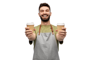 Image showing happy smiling barman in apron with takeaway coffee