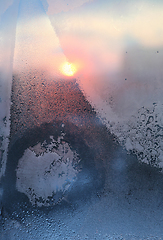 Image showing Ice pattern and water drops on glass on a sunny winter morning