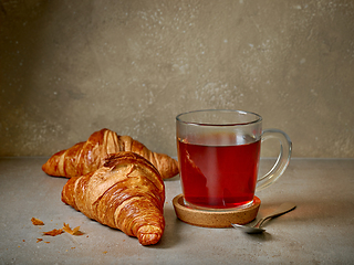 Image showing close up of tea cup and croissants