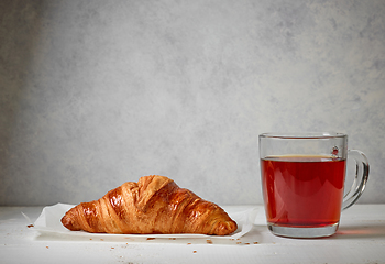 Image showing close up of tea cup and croissant