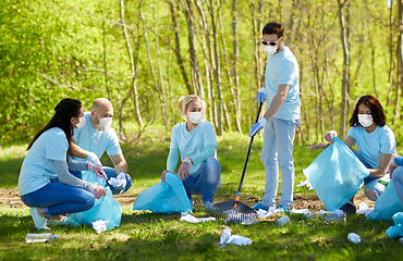 Image showing volunteers in masks with cleaning garbage at park