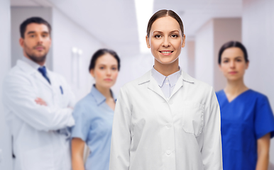 Image showing smiling female doctor with colleagues at hospital