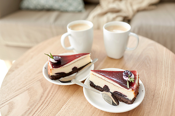 Image showing pieces of chocolate cake on wooden table