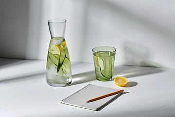 Image showing water with lemon and cucumber and notebook