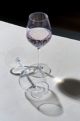 Image showing wine glasses dropping shadows on white surface