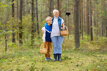 Image showing grandmother and grandson with baskets take selfie