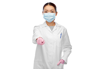 Image showing asian female doctor in mask pointing finger to you