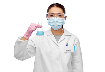 Image showing asian female scientist in mask with chemical