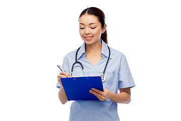 Image showing happy smiling asian female doctor with clipboard