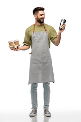 Image showing happy waiter with takeout coffee cups and tumbler