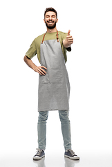 Image showing happy smiling barman in apron showing thumbs up