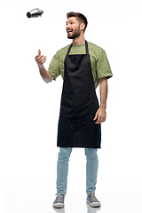 Image showing happy barman in apron with shaker preparing drink