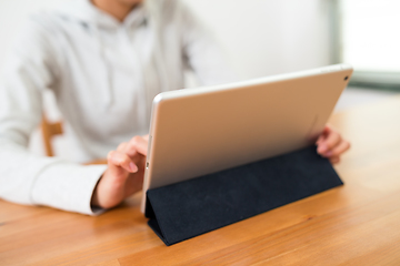 Image showing Woman using tablet computer at home