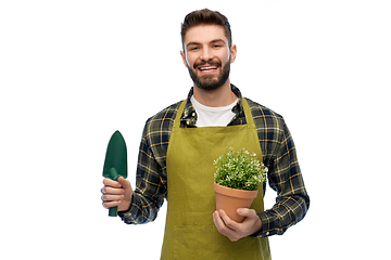 Image showing happy gardener or farmer with trowel and flower