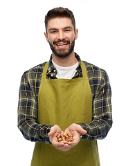 Image showing happy young male gardener or farmer with bulbs