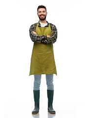 Image showing happy young male gardener or farmer in apron