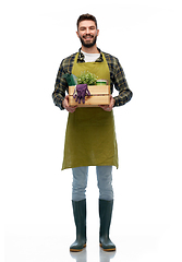 Image showing happy gardener or farmer with box of garden tools