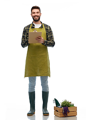 Image showing happy gardener with clipboard with garden tools