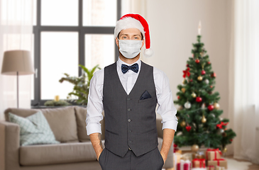 Image showing man in santa hat and medical mask on christmas