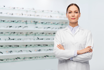 Image showing female doctor in white coat at optical store