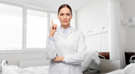 Image showing female doctor pointing finger up at hospital