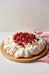 Image showing pavlova meringue cake with berries on wooden board