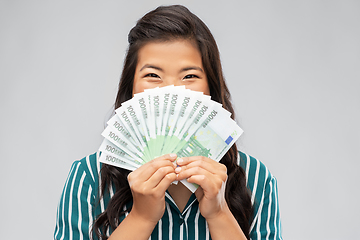 Image showing asian woman with hundred euro money banknotes