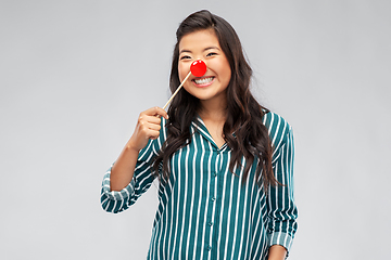 Image showing happy asian woman with red clown nose