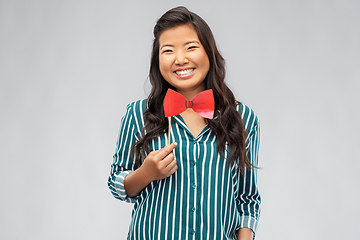 Image showing happy asian woman with red party bow