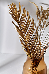 Image showing decorative dried flowers in brown glass vase