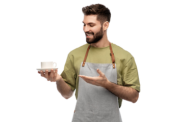 Image showing happy smiling waiter in apron with cup of coffee