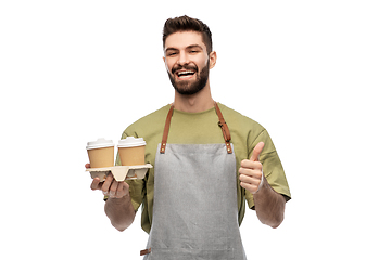 Image showing happy waiter with takeout coffee showing thumbs up