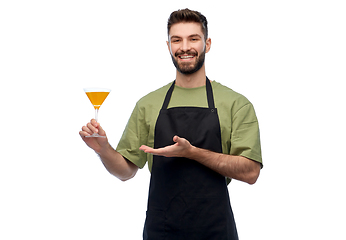 Image showing happy barman in apron with glass of cocktail