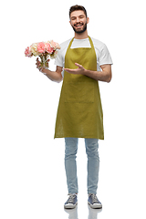 Image showing happy smiling male gardener with flowers in vase