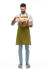 Image showing happy smiling male gardener with flowers in vase