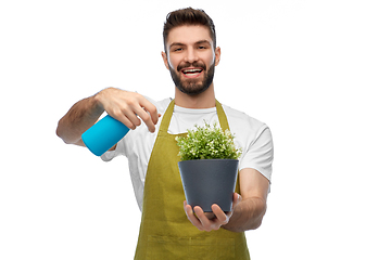 Image showing happy smiling male gardener moisturizing flower