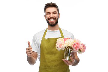 Image showing happy male gardener with flowers showing thumbs up