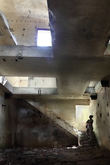 Image showing A woman looking at the ruins of a building